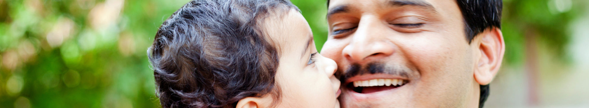Toddler son gives father kiss